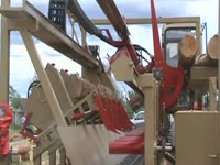 Portable Twin-Cut sawmill loading first log