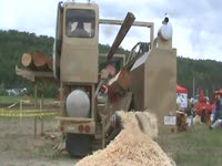 Twin-Cut Sawmill gathering a sawdust pile